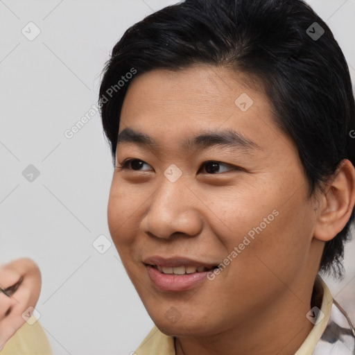 Joyful asian young-adult male with short  brown hair and brown eyes