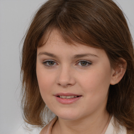 Joyful white child female with medium  brown hair and brown eyes