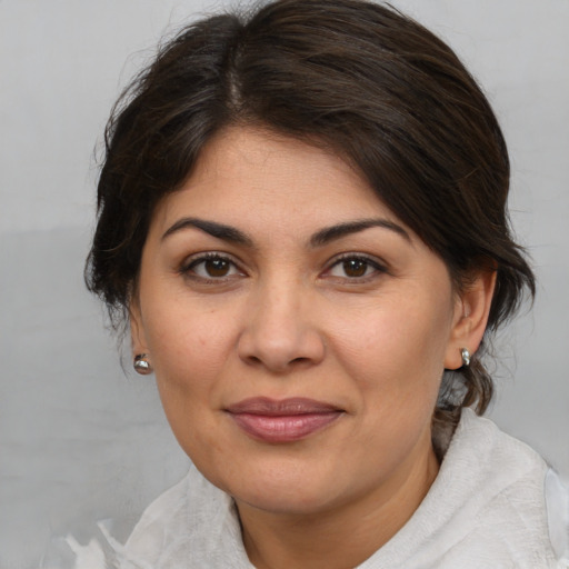 Joyful white adult female with medium  brown hair and brown eyes
