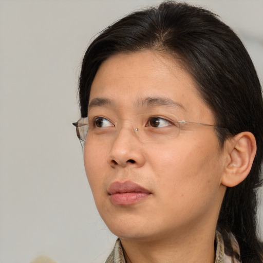 Neutral asian adult female with medium  brown hair and brown eyes