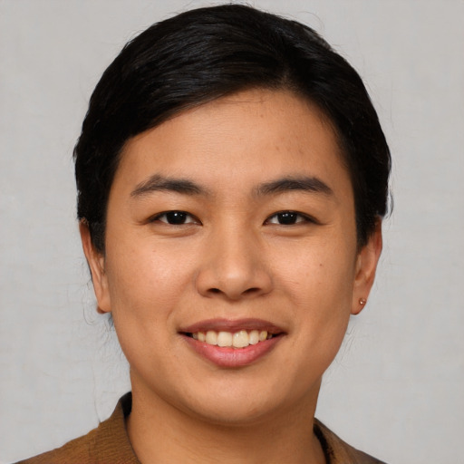 Joyful asian young-adult female with short  black hair and brown eyes