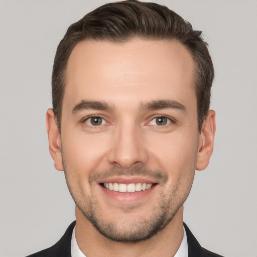 Joyful white young-adult male with short  brown hair and brown eyes