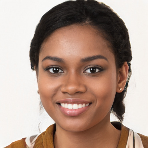 Joyful black young-adult female with long  black hair and brown eyes