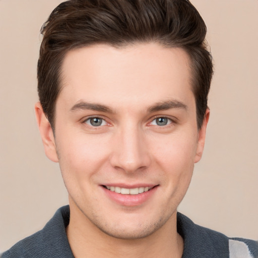 Joyful white young-adult male with short  brown hair and grey eyes