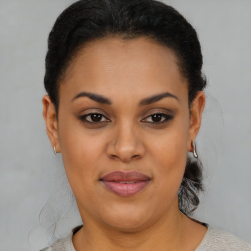 Joyful black young-adult female with short  brown hair and brown eyes