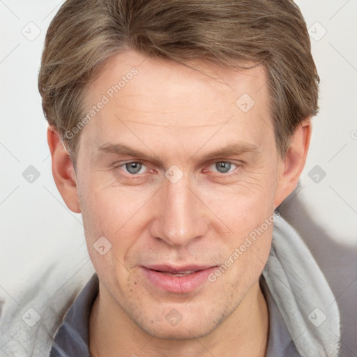 Joyful white adult male with short  brown hair and grey eyes