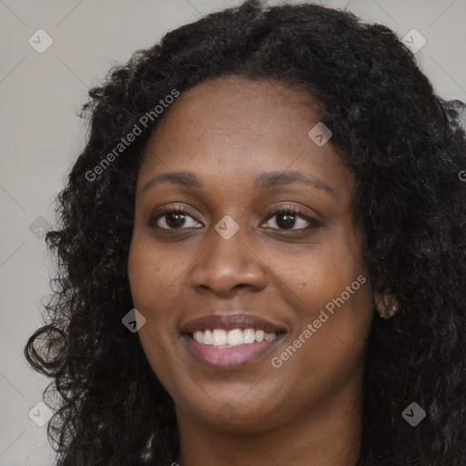 Joyful black young-adult female with long  brown hair and brown eyes