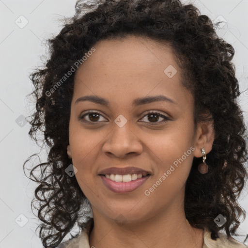 Joyful black young-adult female with long  brown hair and brown eyes