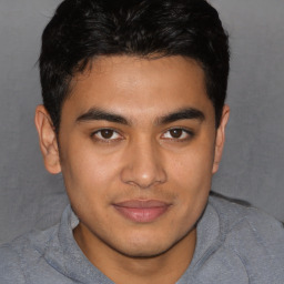 Joyful latino young-adult male with short  brown hair and brown eyes