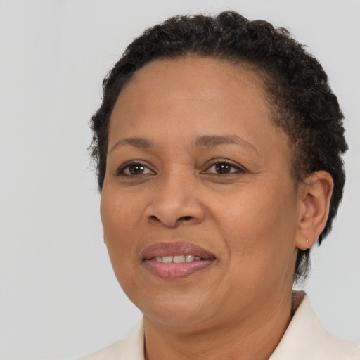 Joyful black adult female with short  brown hair and brown eyes