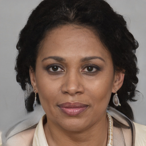 Joyful black adult female with medium  brown hair and brown eyes