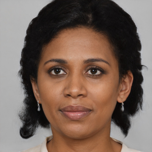 Joyful black young-adult female with medium  black hair and brown eyes