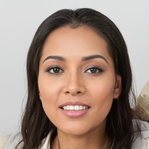 Joyful white young-adult female with long  brown hair and brown eyes