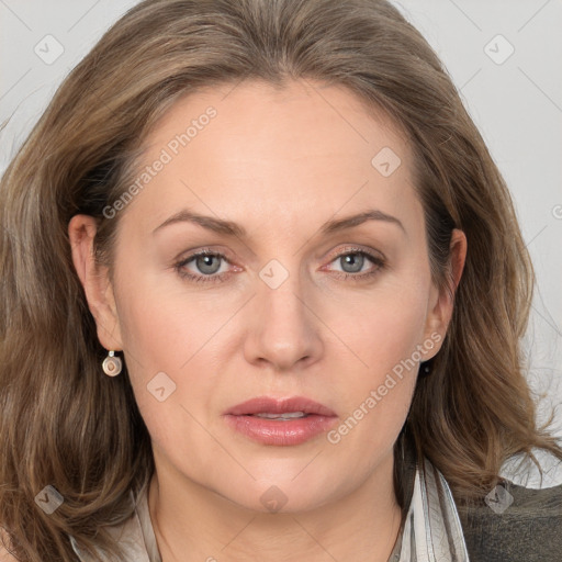 Joyful white adult female with long  brown hair and grey eyes