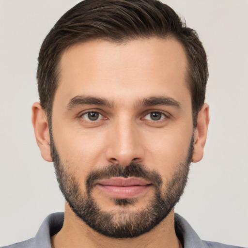 Joyful white young-adult male with short  brown hair and brown eyes