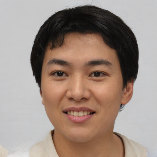 Joyful asian young-adult male with short  black hair and brown eyes