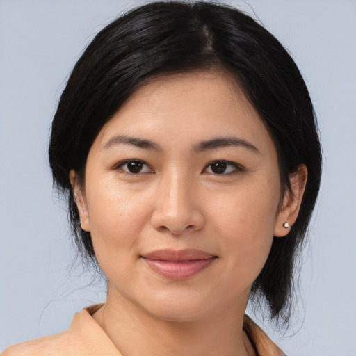 Joyful asian young-adult female with medium  black hair and brown eyes