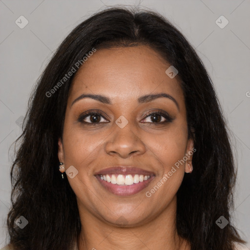 Joyful black young-adult female with long  brown hair and brown eyes