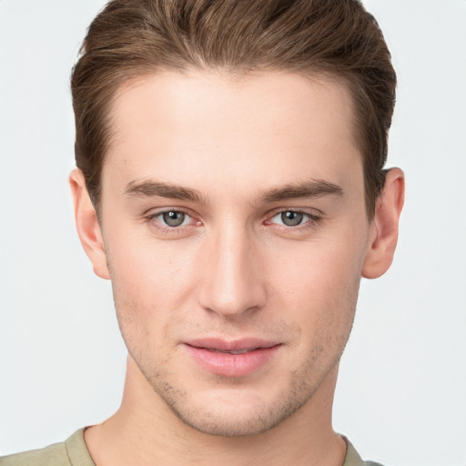 Joyful white young-adult male with short  brown hair and grey eyes