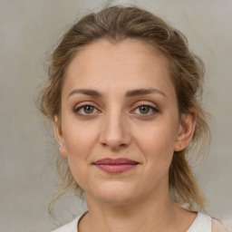 Joyful white young-adult female with medium  brown hair and green eyes