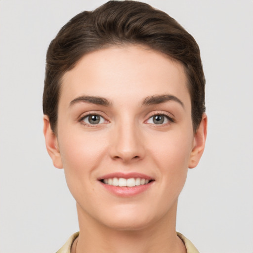 Joyful white young-adult female with short  brown hair and brown eyes