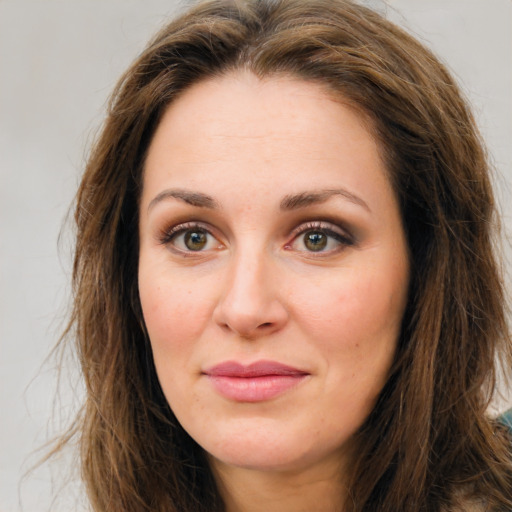 Joyful white young-adult female with long  brown hair and green eyes