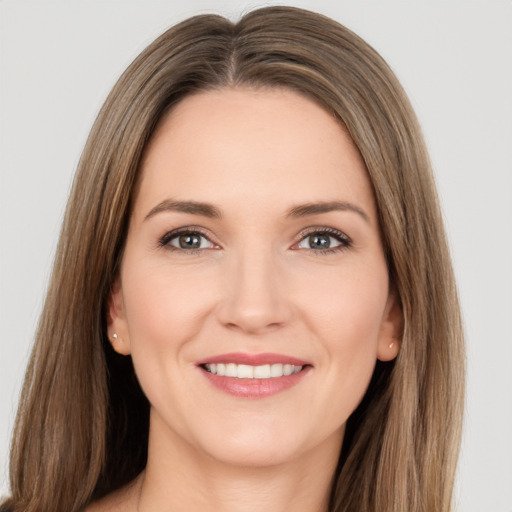 Joyful white young-adult female with long  brown hair and brown eyes