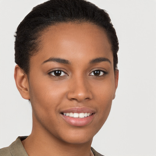 Joyful black young-adult female with short  brown hair and brown eyes