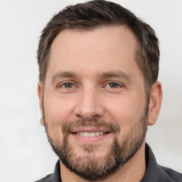 Joyful white adult male with short  brown hair and brown eyes