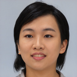 Joyful asian young-adult female with medium  black hair and brown eyes