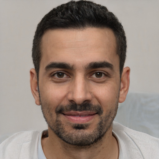 Joyful white young-adult male with short  black hair and brown eyes