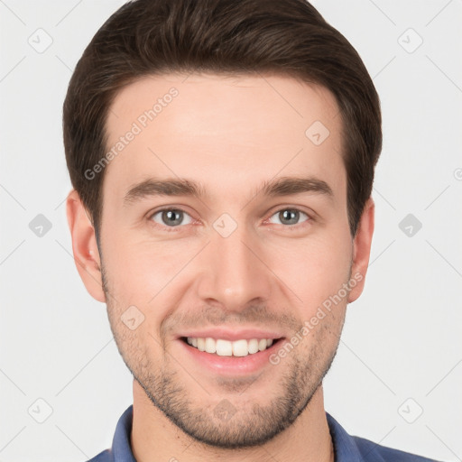 Joyful white young-adult male with short  brown hair and grey eyes