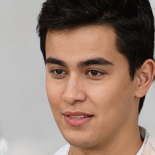 Joyful latino young-adult male with short  brown hair and brown eyes