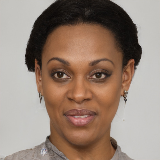 Joyful latino adult female with short  black hair and brown eyes