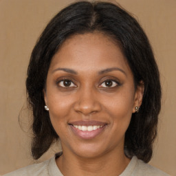 Joyful latino young-adult female with medium  brown hair and brown eyes