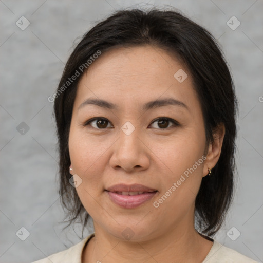 Joyful asian adult female with medium  brown hair and brown eyes