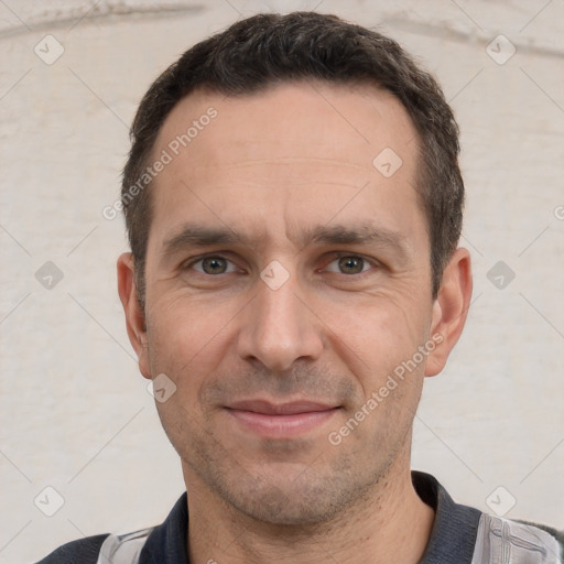 Joyful white adult male with short  black hair and brown eyes