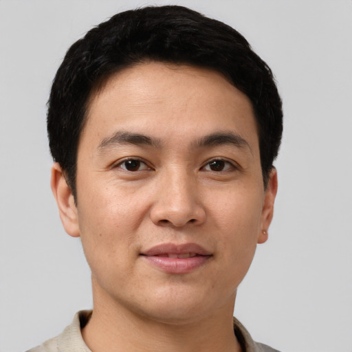 Joyful white young-adult male with short  black hair and brown eyes