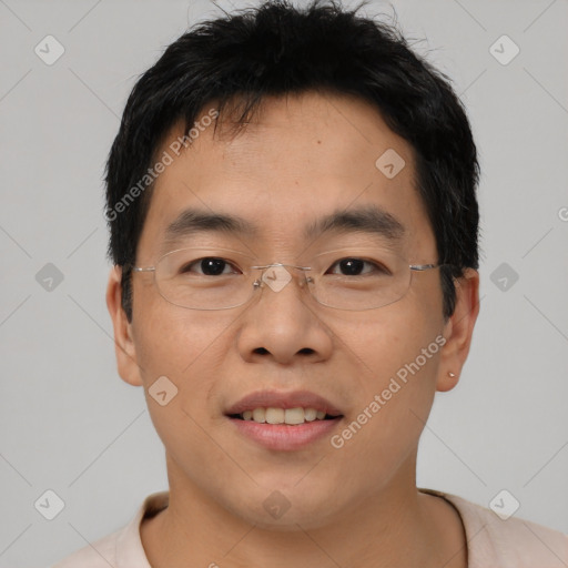 Joyful asian young-adult male with short  brown hair and brown eyes