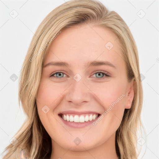 Joyful white young-adult female with long  brown hair and blue eyes