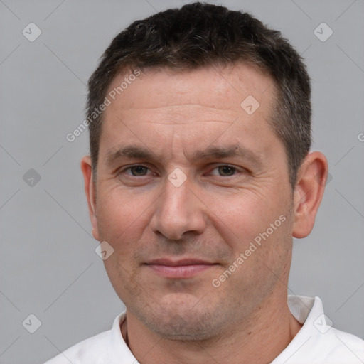 Joyful white adult male with short  brown hair and brown eyes