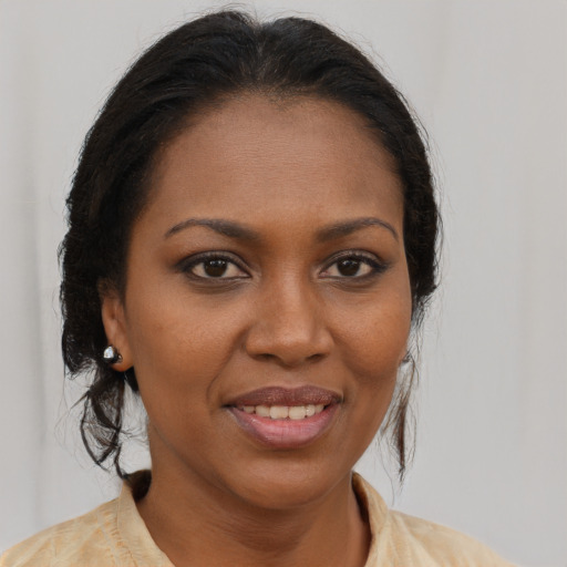 Joyful black young-adult female with medium  brown hair and brown eyes
