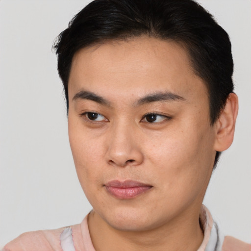 Joyful asian young-adult male with short  brown hair and brown eyes
