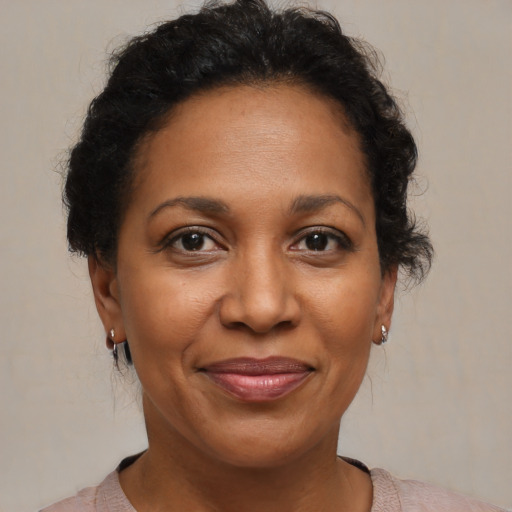 Joyful black adult female with short  brown hair and brown eyes