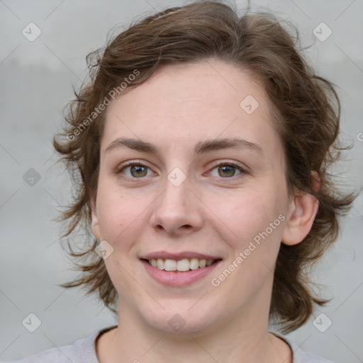 Joyful white young-adult female with medium  brown hair and green eyes