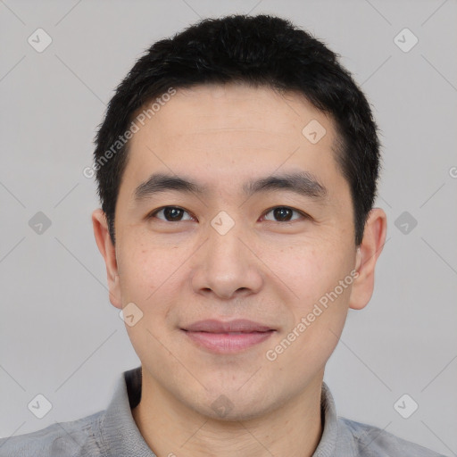 Joyful white young-adult male with short  black hair and brown eyes