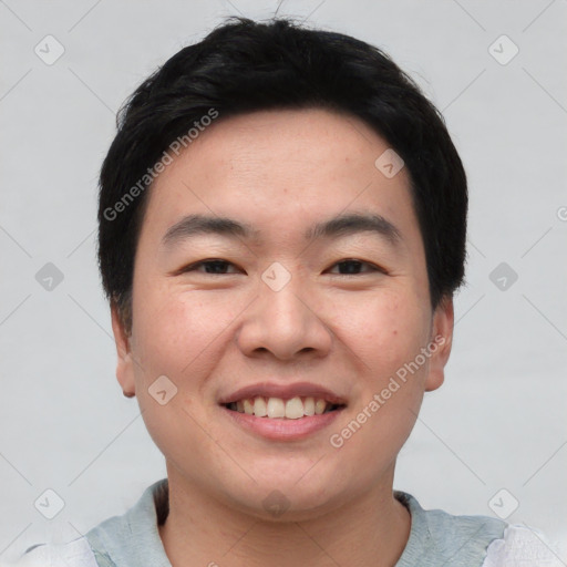 Joyful asian young-adult male with short  black hair and brown eyes