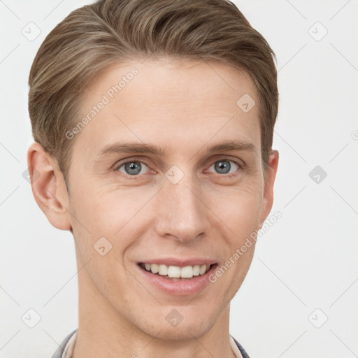 Joyful white young-adult male with short  brown hair and grey eyes