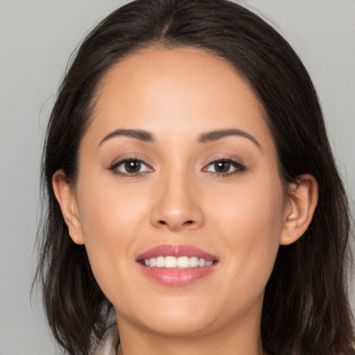 Joyful white young-adult female with long  brown hair and brown eyes