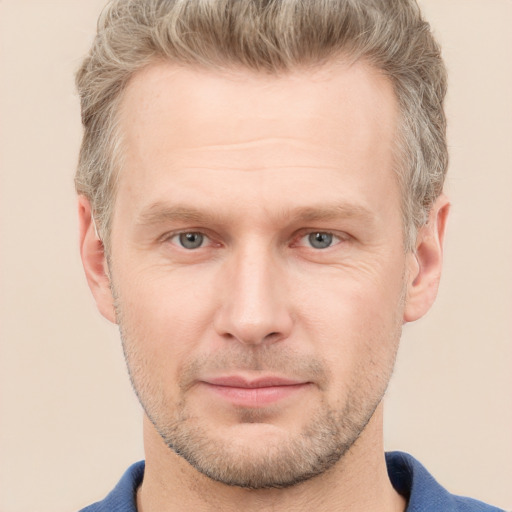 Joyful white adult male with short  brown hair and grey eyes